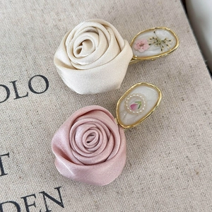 Detail of vintage 3D rose hair clips with silk petals, gold borders and inlaid pearls