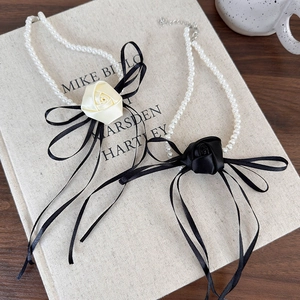 French camellia pearl choker necklace featuring satin rose flowers and black silk ribbons