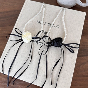 French camellia flower pearl choker necklace with long black ribbon and silk bow detail