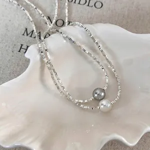 Minimalist silver chain necklace with layered pearls and textured square beads
