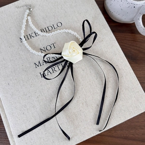 French retro pearl choker featuring a cream satin rose and delicate black silk ribbon bow