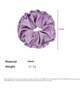 Detail showing oversized purple satin scrunchie with 18cm diameter and silky fabric texture