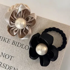 Elegant camellia hair scrunchies with pearls in beige and black satin fabric
