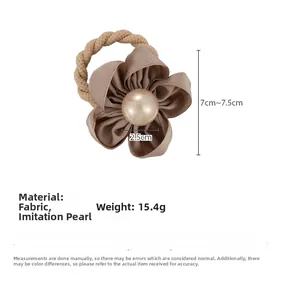 Detail of coffee brown camellia hair tie with 2.5cm pearl inlay and fabric petals