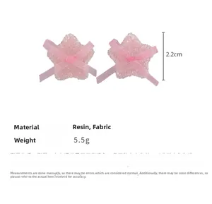 Detail view of pink resin star earrings with ribbon bow featuring frosted texture