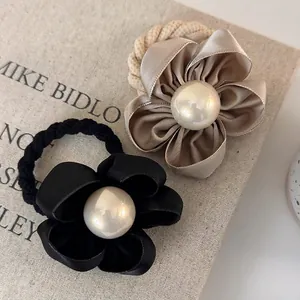 Elegant camellia hair ties with satin petals and faux pearl in black and champagne