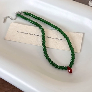 Retro Chinese style necklace with green beads and a red raindrop crystal pendant