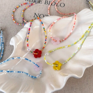 Colorful handmade beaded floral necklace with iridescent pearls and resin flowers
