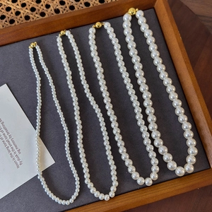 Detailed comparison of four sizes of round white pearl necklaces with gold magnetic clasps
