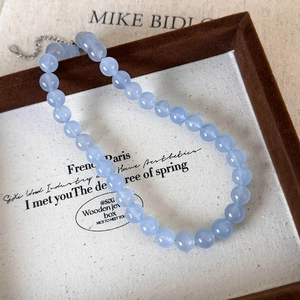 Close-up of light blue beaded stone necklace with adjustable silver lobster clasp