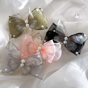 Elegant organza butterfly hair clips with pearls in four soft colors on white silk