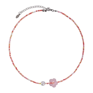 Colorful beaded flower necklace with pink pendant and pearl detail on white background