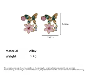 Detail view of floral butterfly earrings with pink enamel and size dimensions 1.8cm x 1.4cm