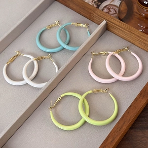 Set of four colorful macaron hoop earrings in light blue, pink, green, and white