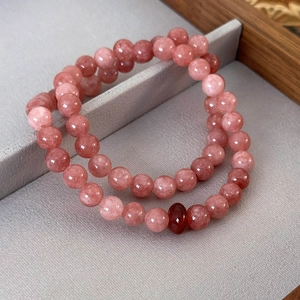 Pink strawberry quartz beaded bracelets set with a red agate peace buckle charm