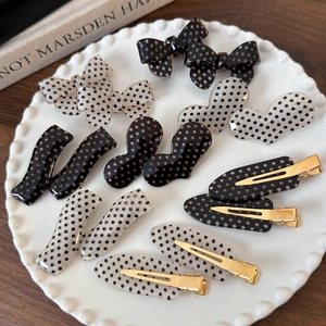 French style polka dot bow hair clips set with gold duckbill clips on ceramic plate
