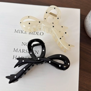 Polka dot bow shark hair claw clips in black and white resin for elegant hair styling