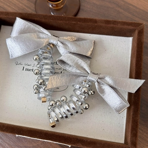 Silver satin bow and spiral telephone wire hair ring set with metallic bead accents
