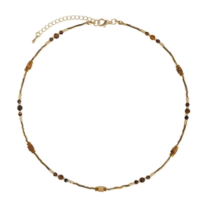 Zen style necklace with natural tiger eye beads and gold accents on a white background