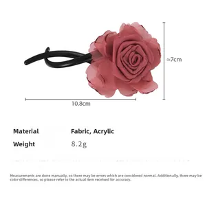 Detail view of handmade fabric rose hair clip with acrylic stick, 10.8cm length