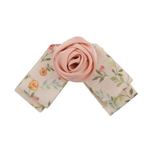 Handmade pink rose fabric hair clip with floral ribbon bow on white background