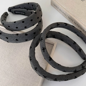 Close-up of gray padded headbands with polka dots and handmade label details