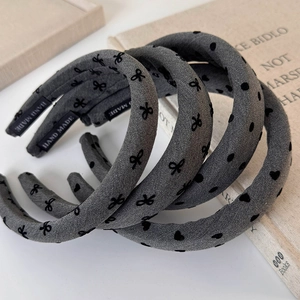 Detail view of handmade grey fabric headbands with bow, polka dots and heart patterns