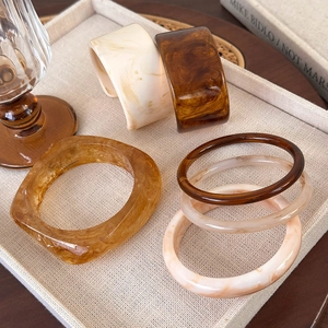 Irregular wide acrylic resin bracelets with vintage marble texture in earthy amber tones