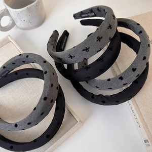 Minimalist grey sponge headband with embroidered heart and bow detail on fabric