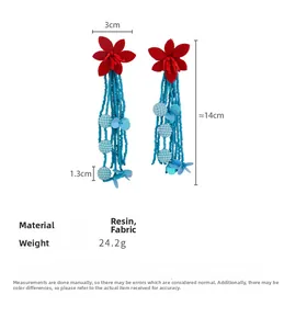 Detailed view of long blue beaded tassel earrings with red fabric flowers and measurements