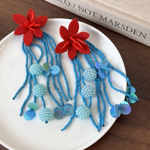 Exaggerated long fringe earrings with red fabric flowers and blue beaded tassel strands