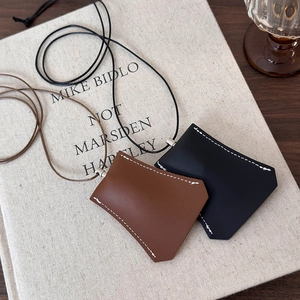 Minimalist faux leather clochette key cases in black and brown with contrast stitching