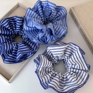 Trois chouchous géants en tissu à rayures bleues et blanches style vacances