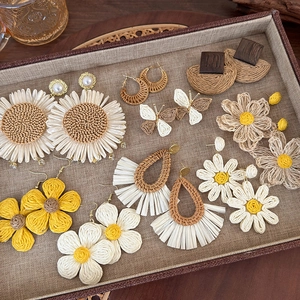 Collection of bohemian straw woven earrings with sunflower and butterfly designs