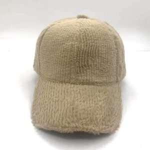 Close-up detail of soft khaki faux cashmere texture on a warm winter baseball cap