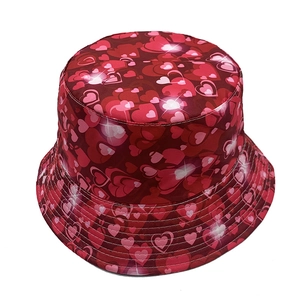 Détail d'un chapeau bob rouge orné de motifs de cœurs variés pour la protection solaire extérieure