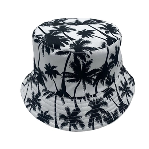 Detail shot of black palm tree print and reinforced stitching on white bucket hat