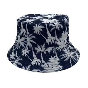 Detail shot of navy blue cotton bucket hat featuring white palm tree prints and fine stitching