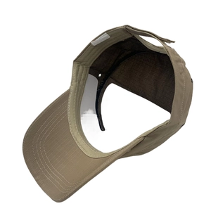 Internal detail of khaki tactical cap showing sweatband, mesh lining, and velcro strap