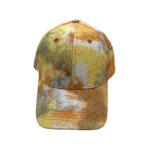 Detailed close-up of a tie-dye baseball cap with yellow and orange marble patterns