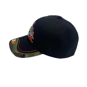 Detail view of black baseball cap featuring camo brim and USA flag eagle embroidery