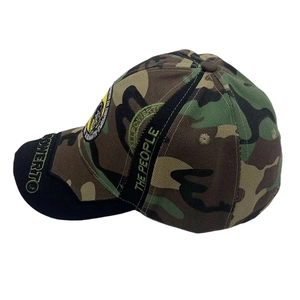 Detail of camouflage baseball cap featuring side embroidery and curved black brim