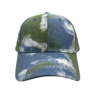 Detailed view of the tie-dye cotton fabric texture on a blue and green baseball cap