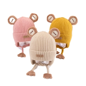 Three colors of cute ribbed knit children's hats with bear ears and pompom chin straps