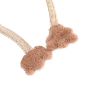 Detail view of knitted cream headband with soft brown faux fur bear paw accents