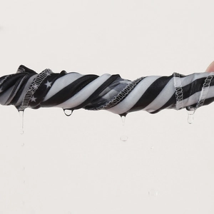 Detail of moisture-wicking fabric showing water drainage and high-quality edge stitching