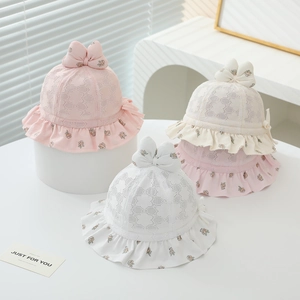 Detail of pink and white baby sun hats with delicate lace mesh and floral frill brims