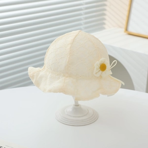 Detailed view of baby lace sun hat featuring a yellow daisy and ruffled brim
