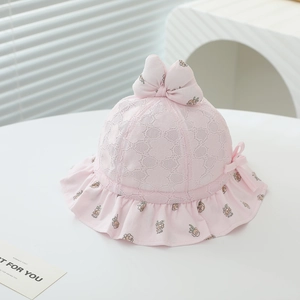 Close-up of pink baby sun hat with delicate white floral lace and a cute 3D bow detail