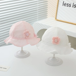 Detail of pink and white baby sun hats with delicate lace floral embroidery and bow accents